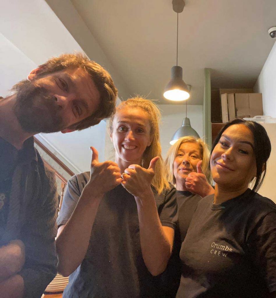 The crumbs kitchen staff giving the thumbs up